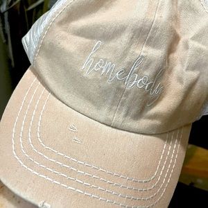 Pink hat that says “home body”